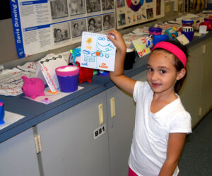 Student showing off her work