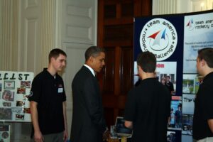 President Obama talks with PM team members