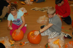 Students carving pumpkins