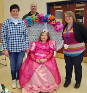 Emily poses with her parents, Kerry, left, and Tim Graver, and Tammy Martelle, who made Emily's dress.