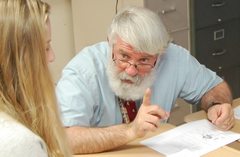 Teacher Joe Herman gestures as he talks with a student.