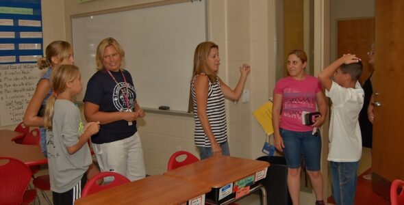 Hambright sixth-grade teacher Beth Wagner, center, talks to parents and students at Thursday's orientation.