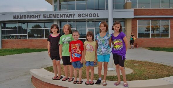 Incoming students pose in front of their new school.