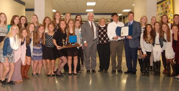 School board members with field hockey team