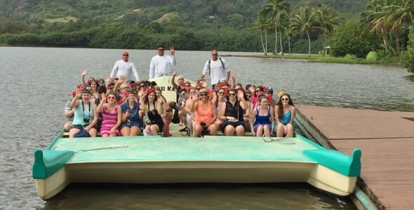 Students and chaperones depart for "Secret Island," a private beach that featured paddle boards, kayaks and beach volleyball.