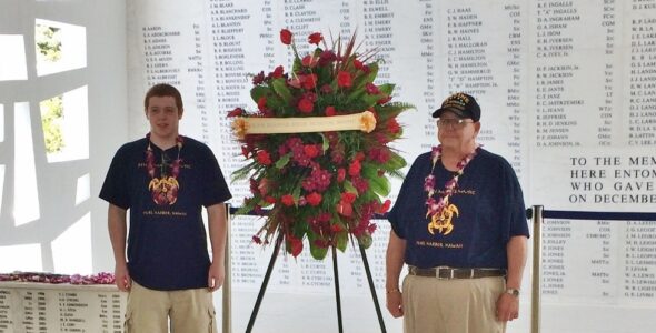 PMHS student Colin Mathiot and his grandfather, Bill Engle, a Vietnam Veteran, place a Penn Manor wreath at the site of the U.S.S. Arizona memorial.