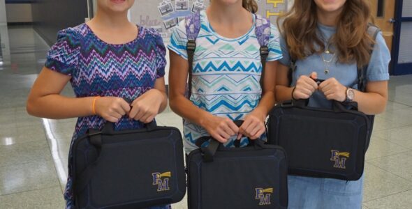 Emma Hoback, Lilli Barton and Rebecca Groff with their laptops.