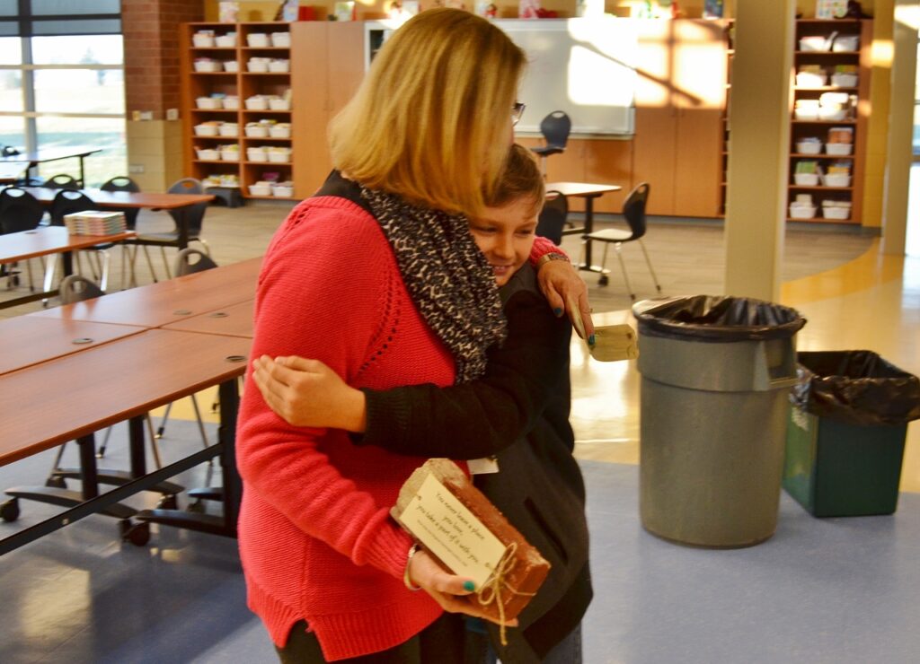 Student and teacher with brick