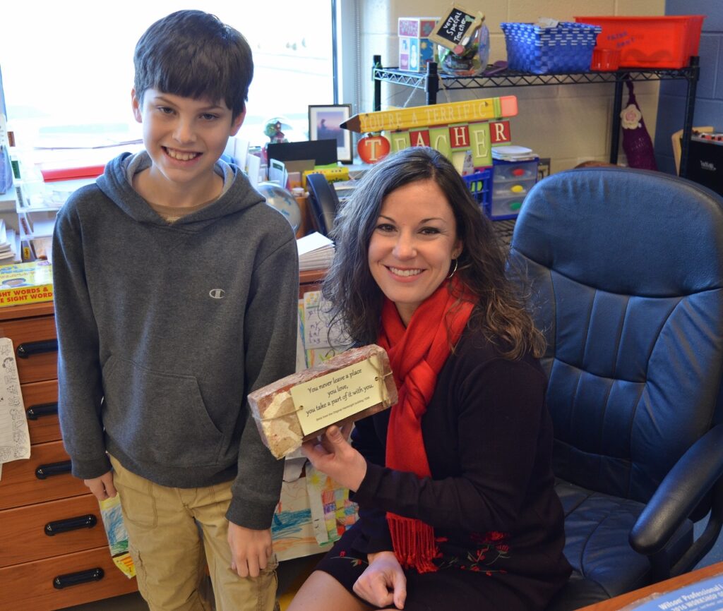 Student and teacher with brick