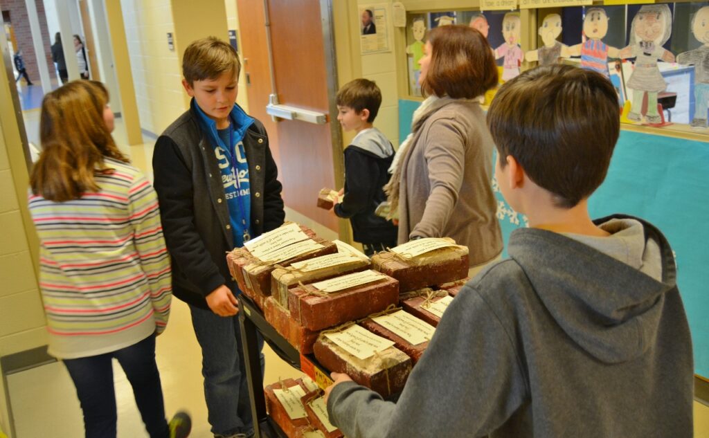 Students passing out bricks