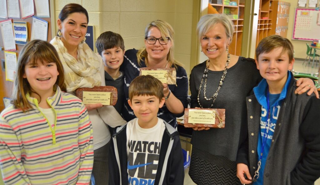 Students and teachers pose with Hambright bricks