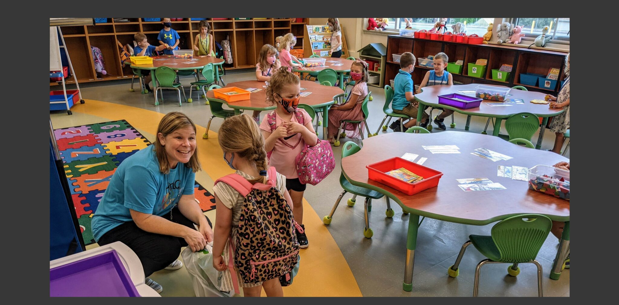 Photo of kindergarten teacher with students in classroom