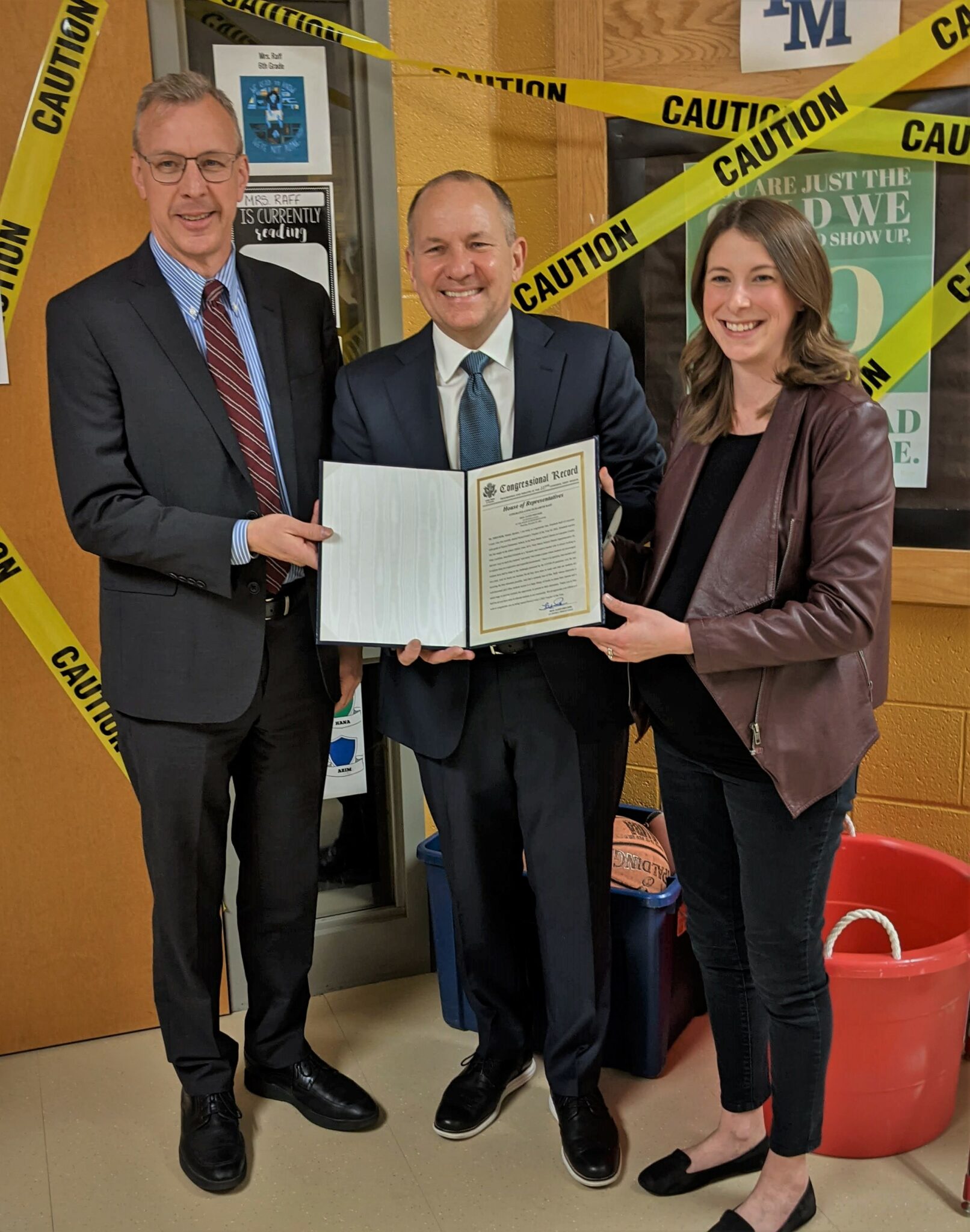 Penn Manor superintendent Mike Leichliter, U.S. Rep Lloyd Smucker and Pequea teacher Elizabeth Raff with the commendation read on the floor of Congress.