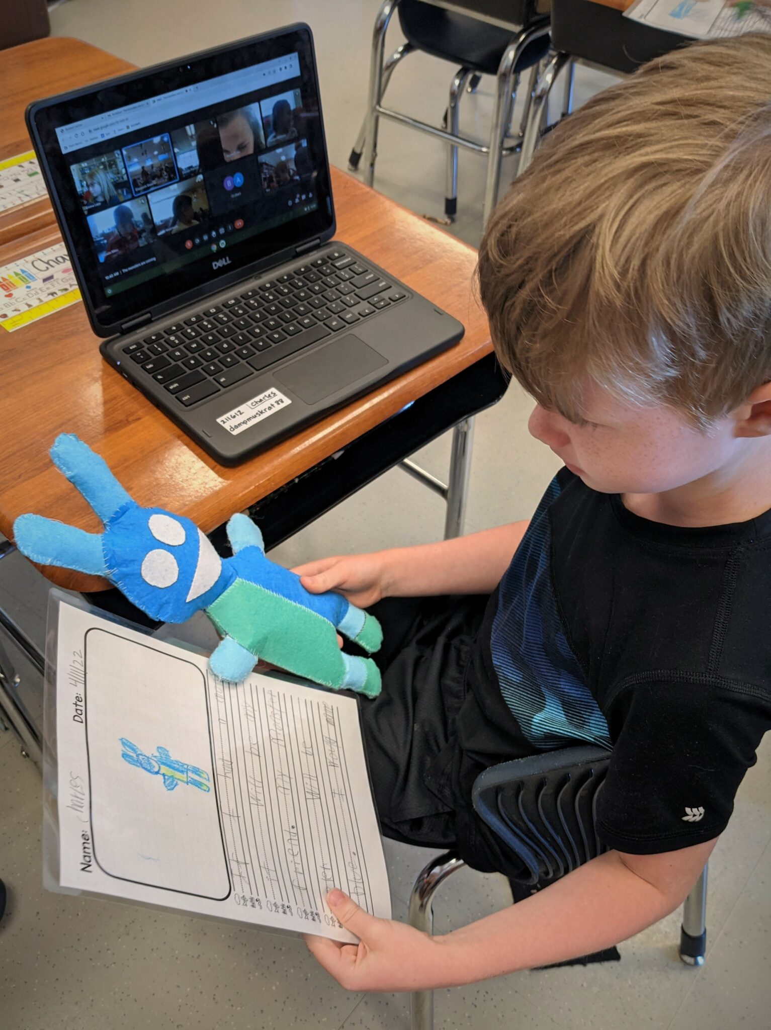 Photo of one student comparing his monster to the description he wrote