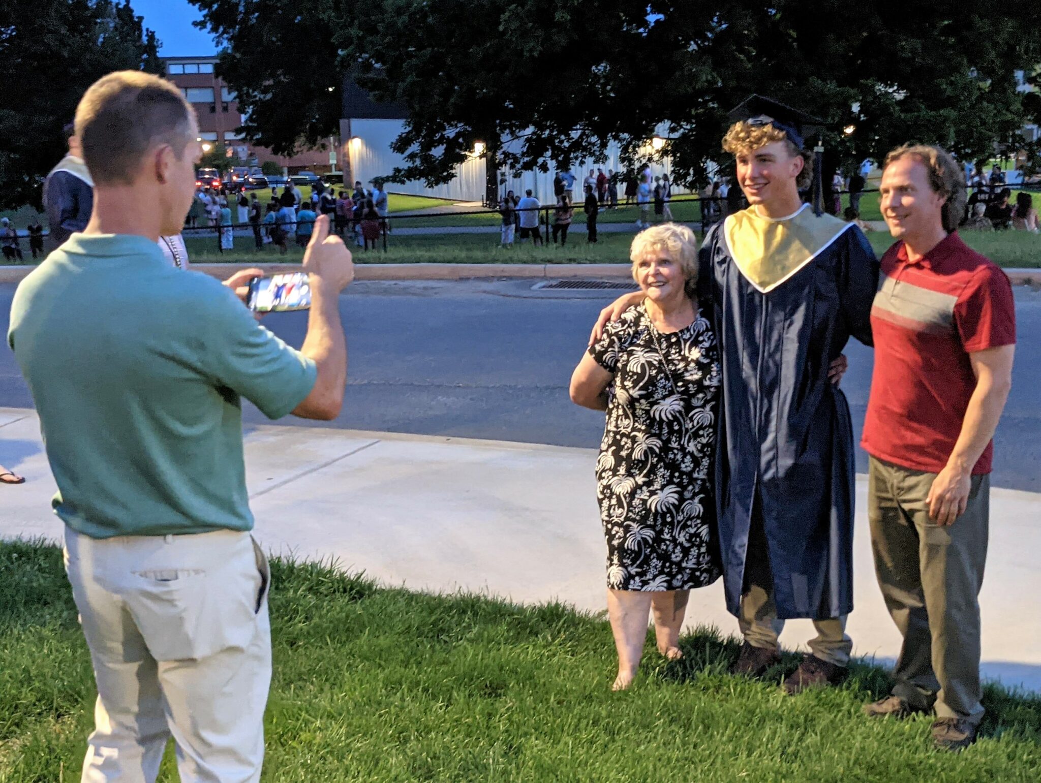 Photo of family taking a picture of graduate.