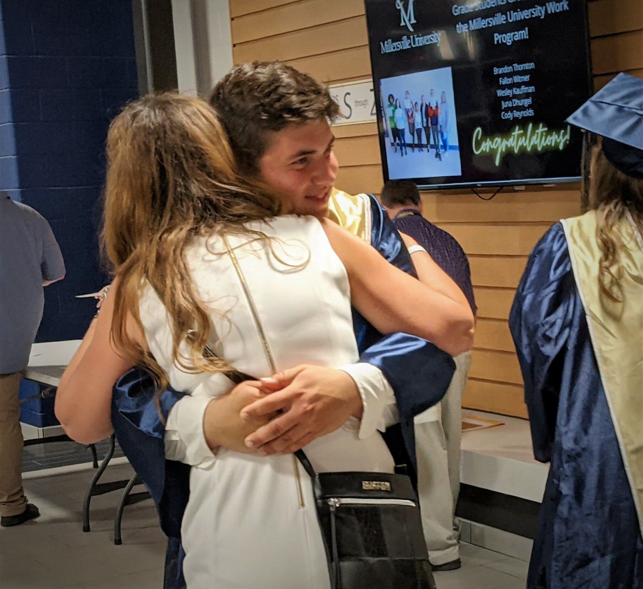 Photo of two students hugging