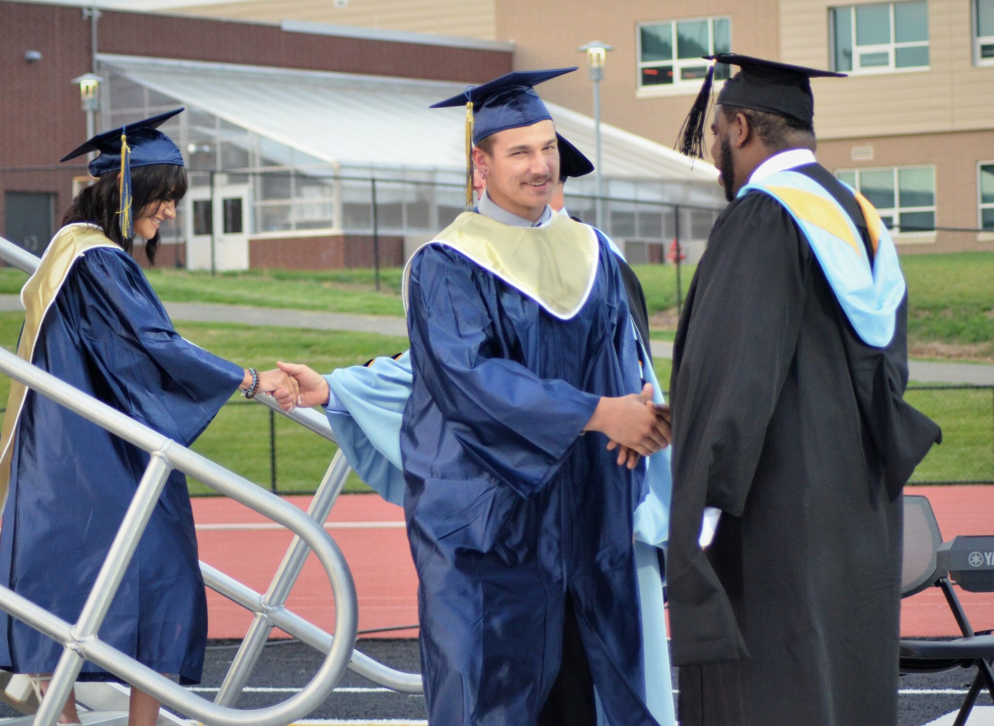 Photo of the principal congratulating a graduate