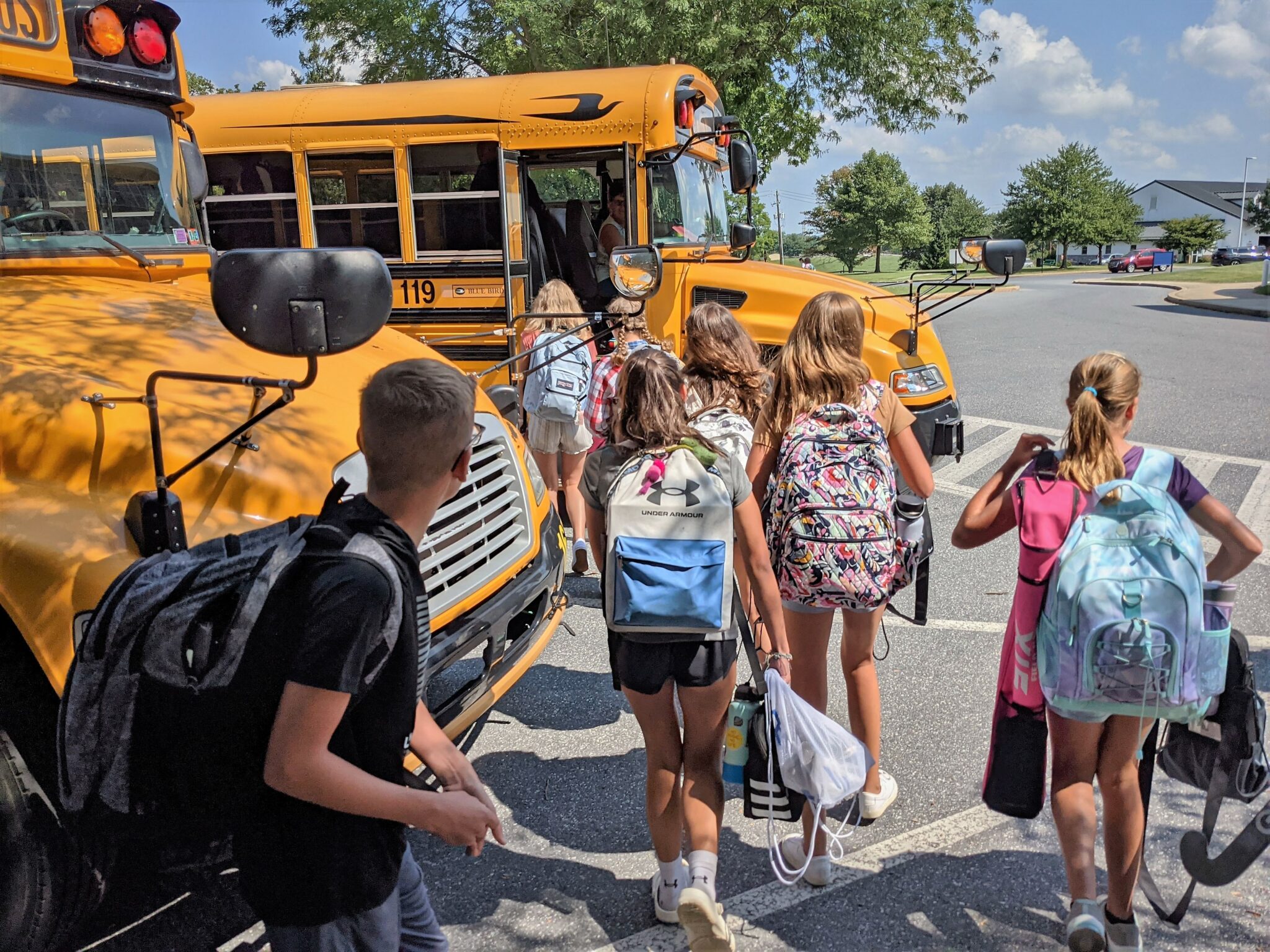 Photo of students getting on bus at Manor Middle School