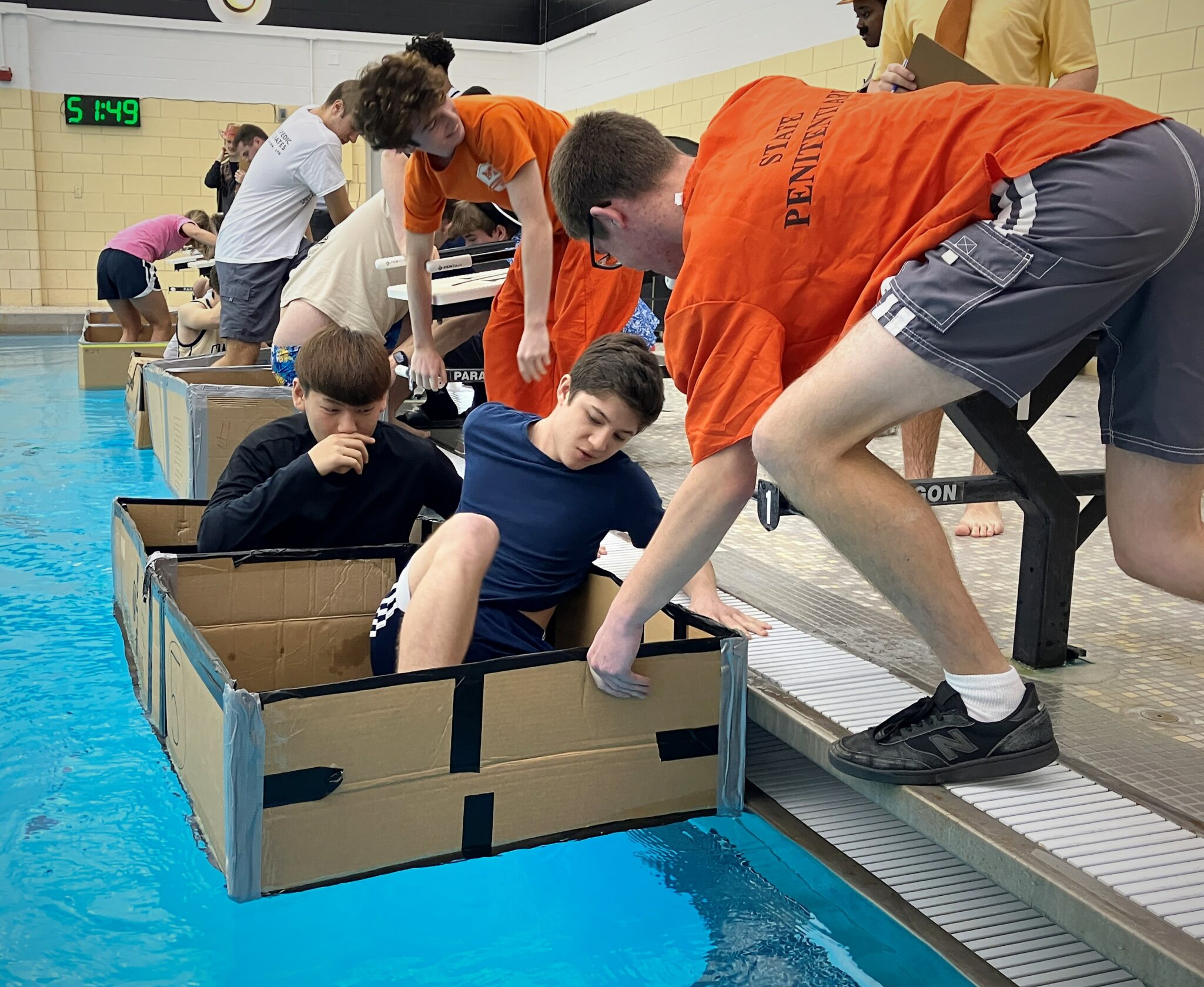 Photo of students entering carboard boat