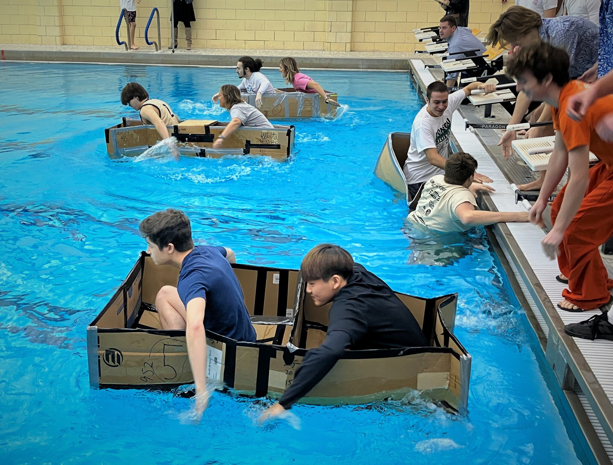 Photo of students paddling carboard boats