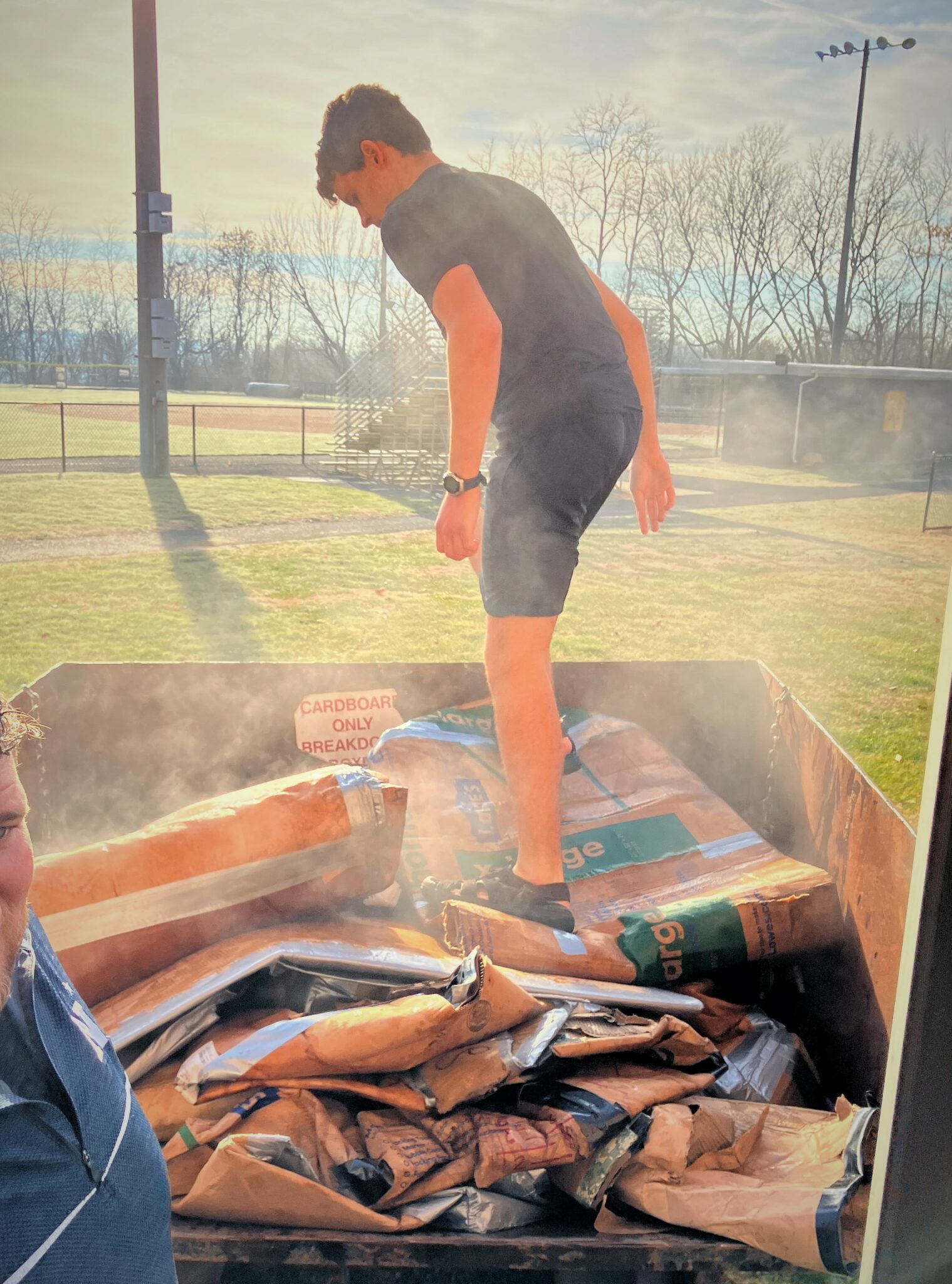 Photo of student breaking down carboard after the competiton