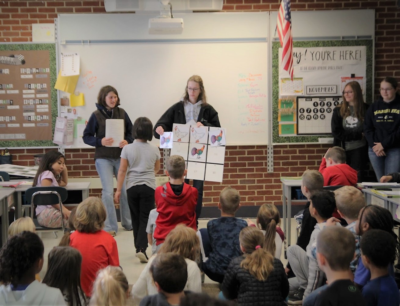 Photo of students presenting information in the library.