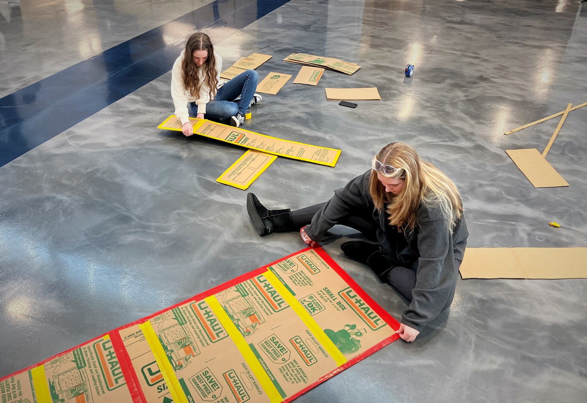 Photo of students building cardboard boats