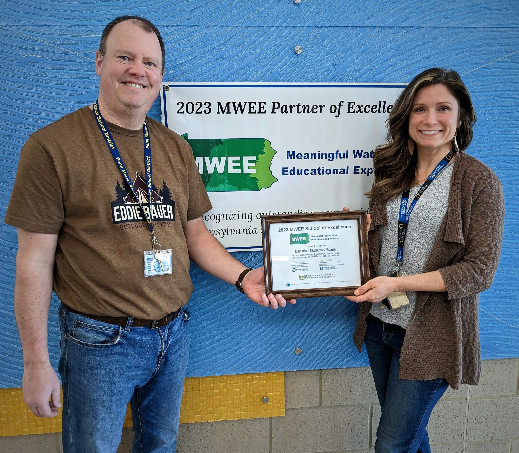 Photo of teachers Bradley Showalter and Katie Harnish holding the watershed award.