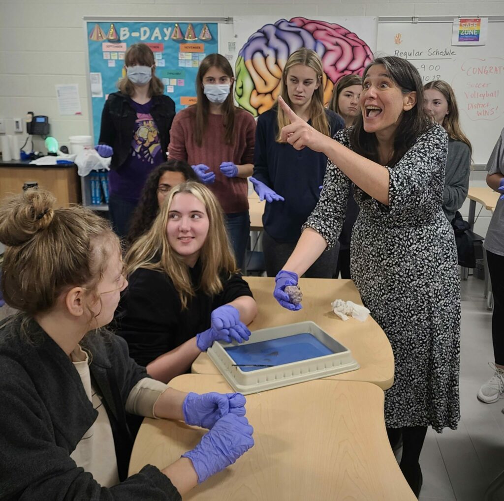 Maria Vita in the classroom with eight students.