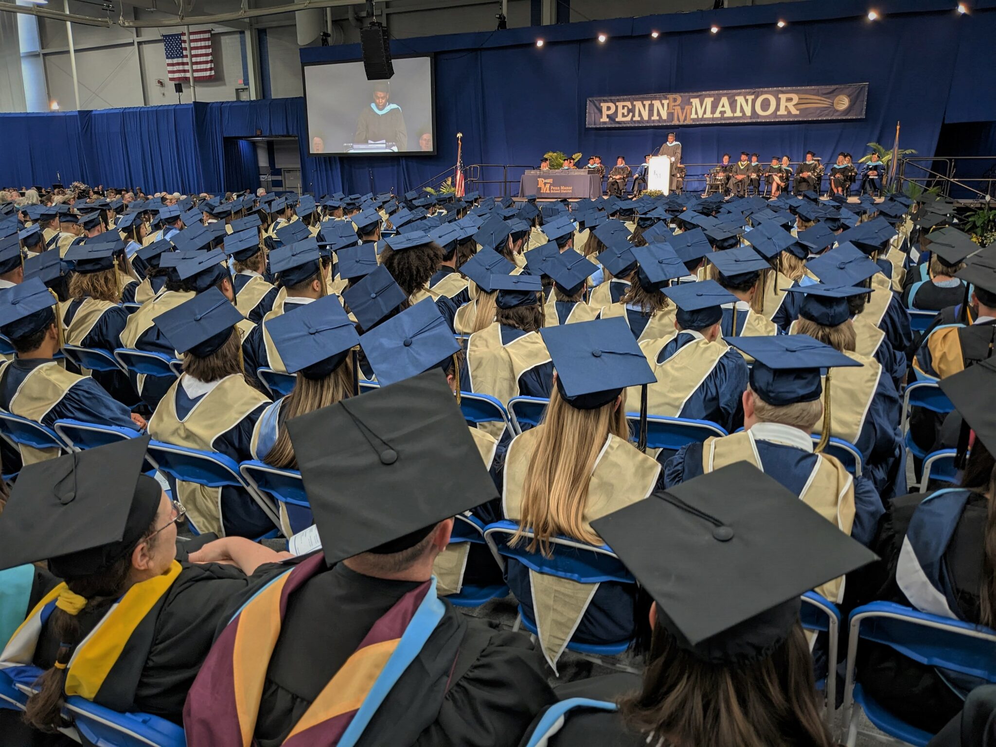 Photo of hundreds of graduates looking toward the stage