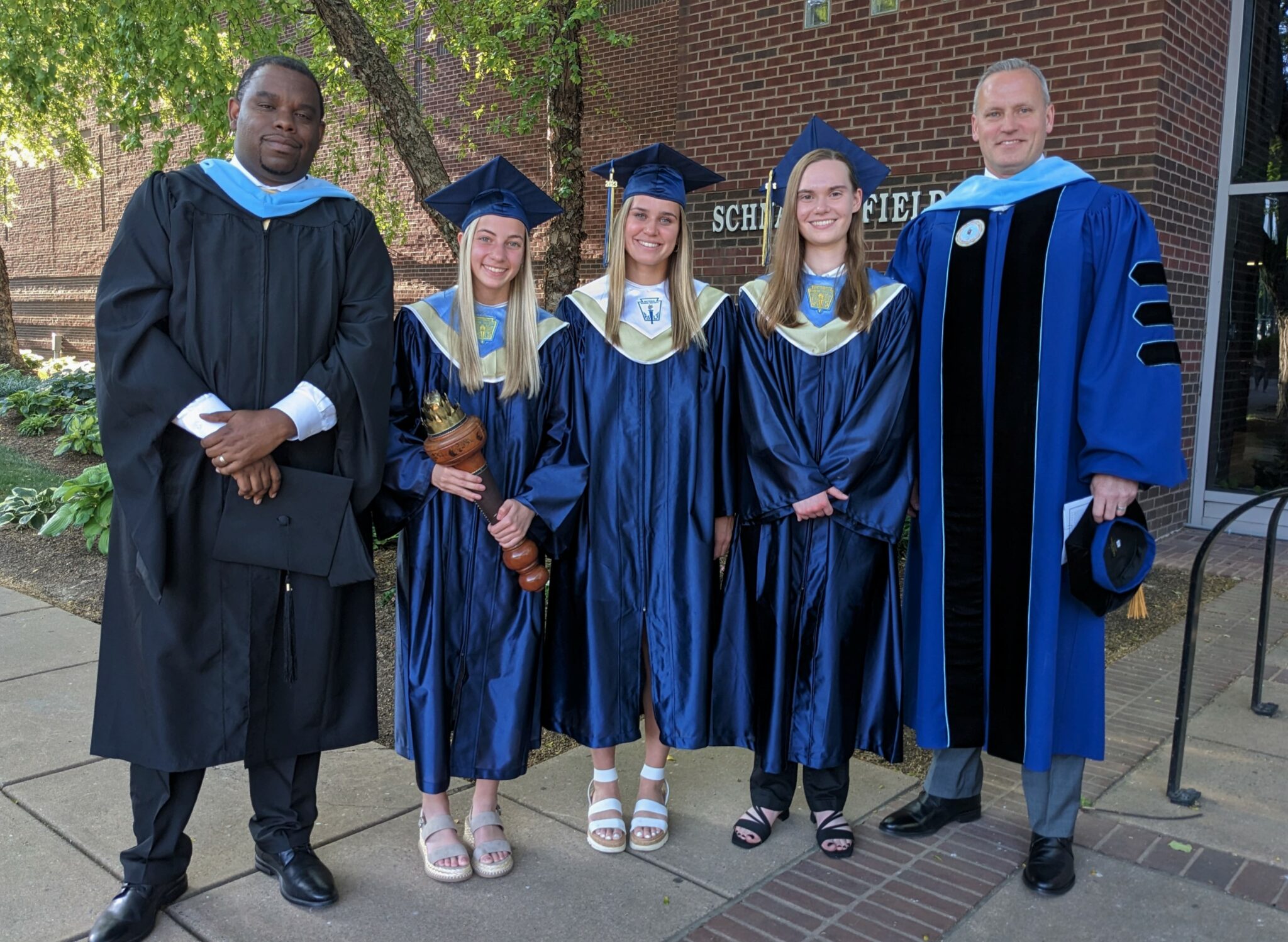 Photo of principal, superintendent and three commencement speakers