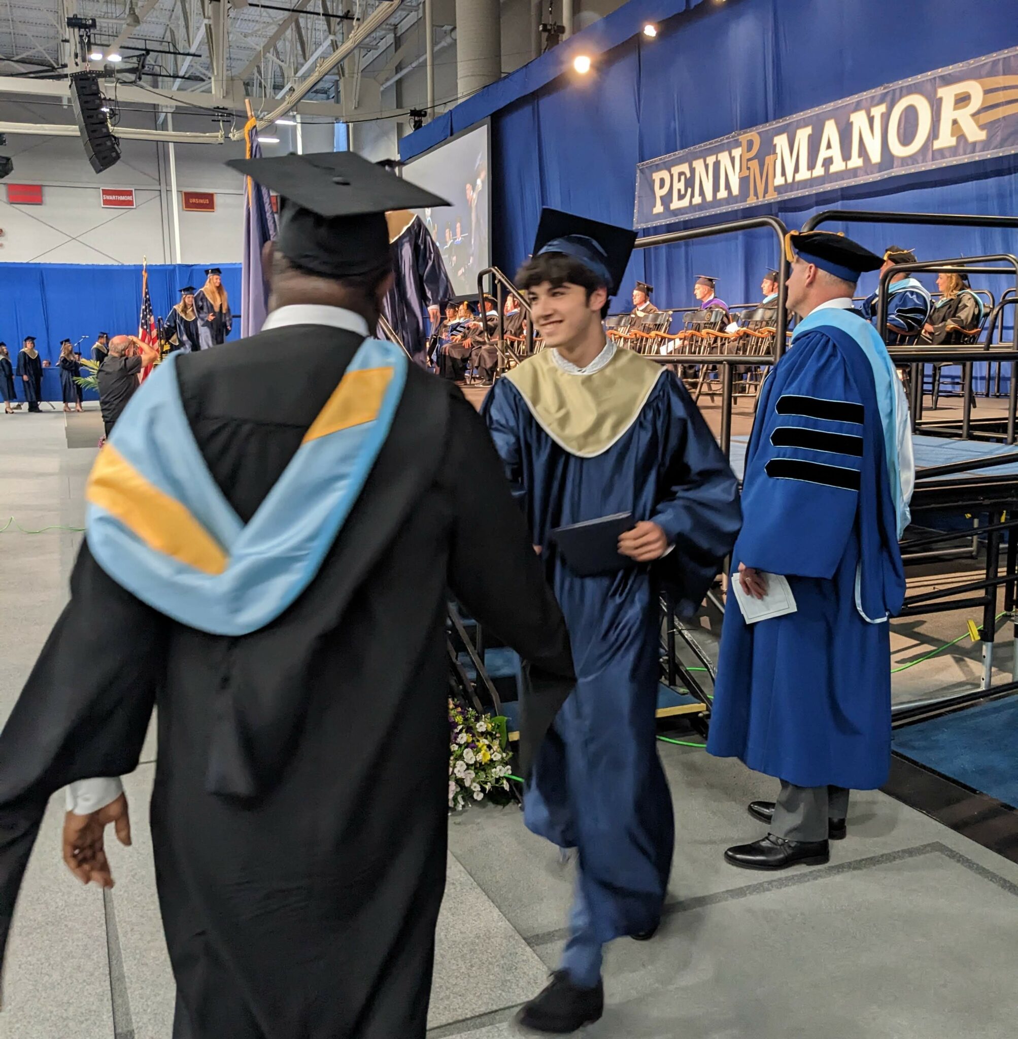 Photo of graduate receiving handshake