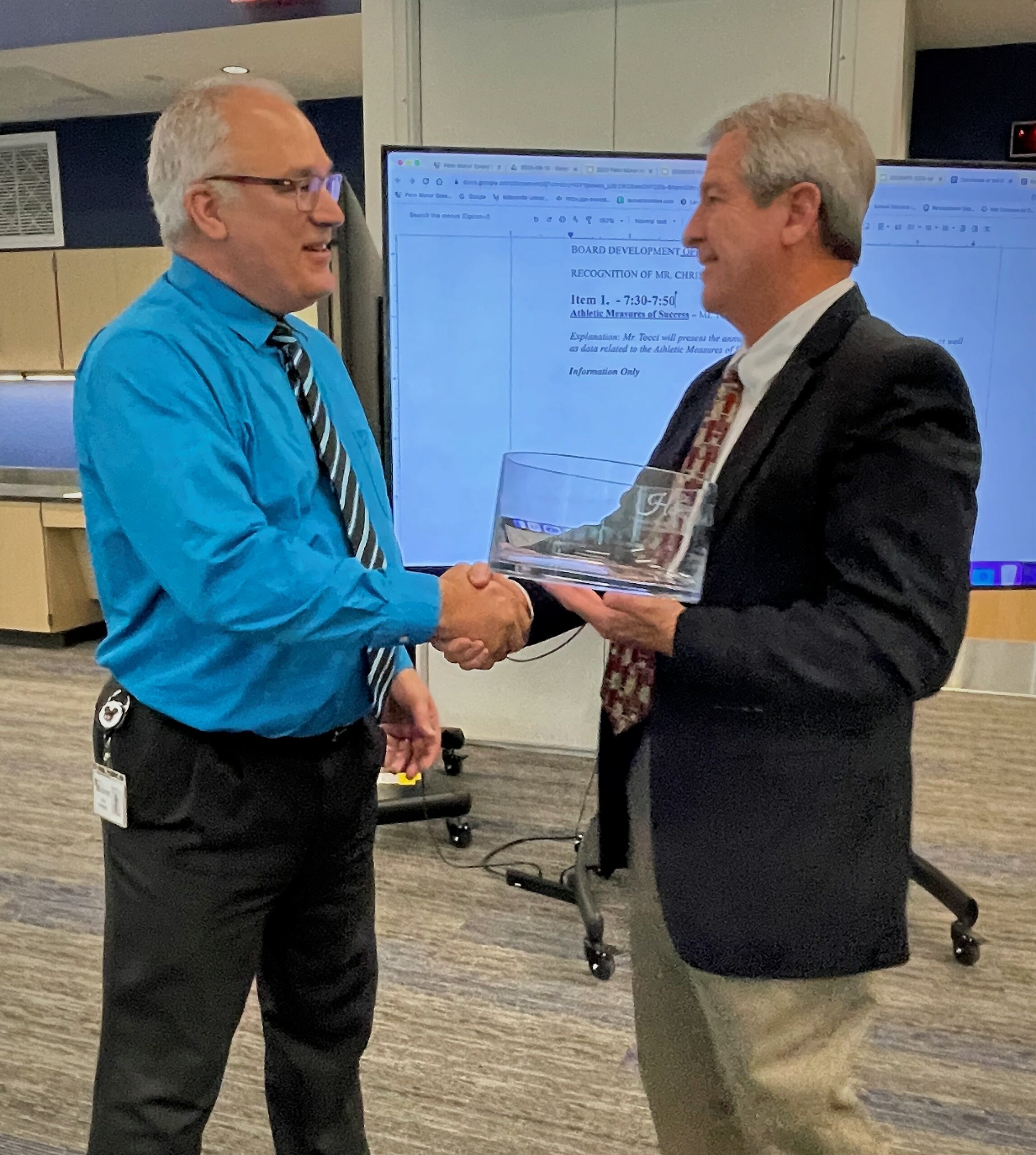 Chris Johnston and school board president Herk Rintz.