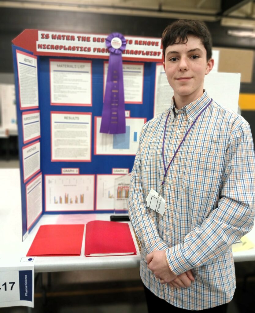 Jack Ryan stands with his project and awards.