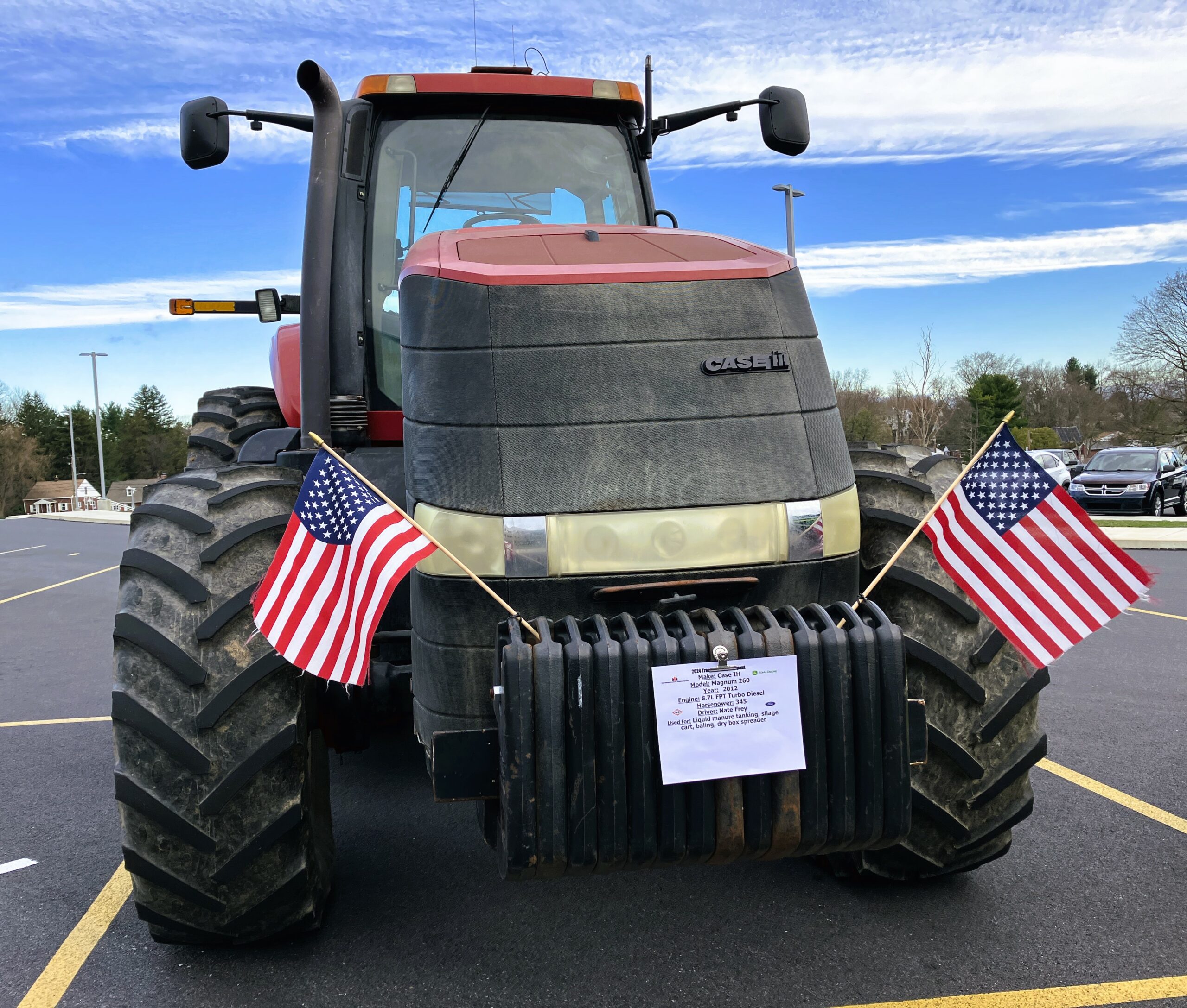 A large red tractor adorned with American flags.