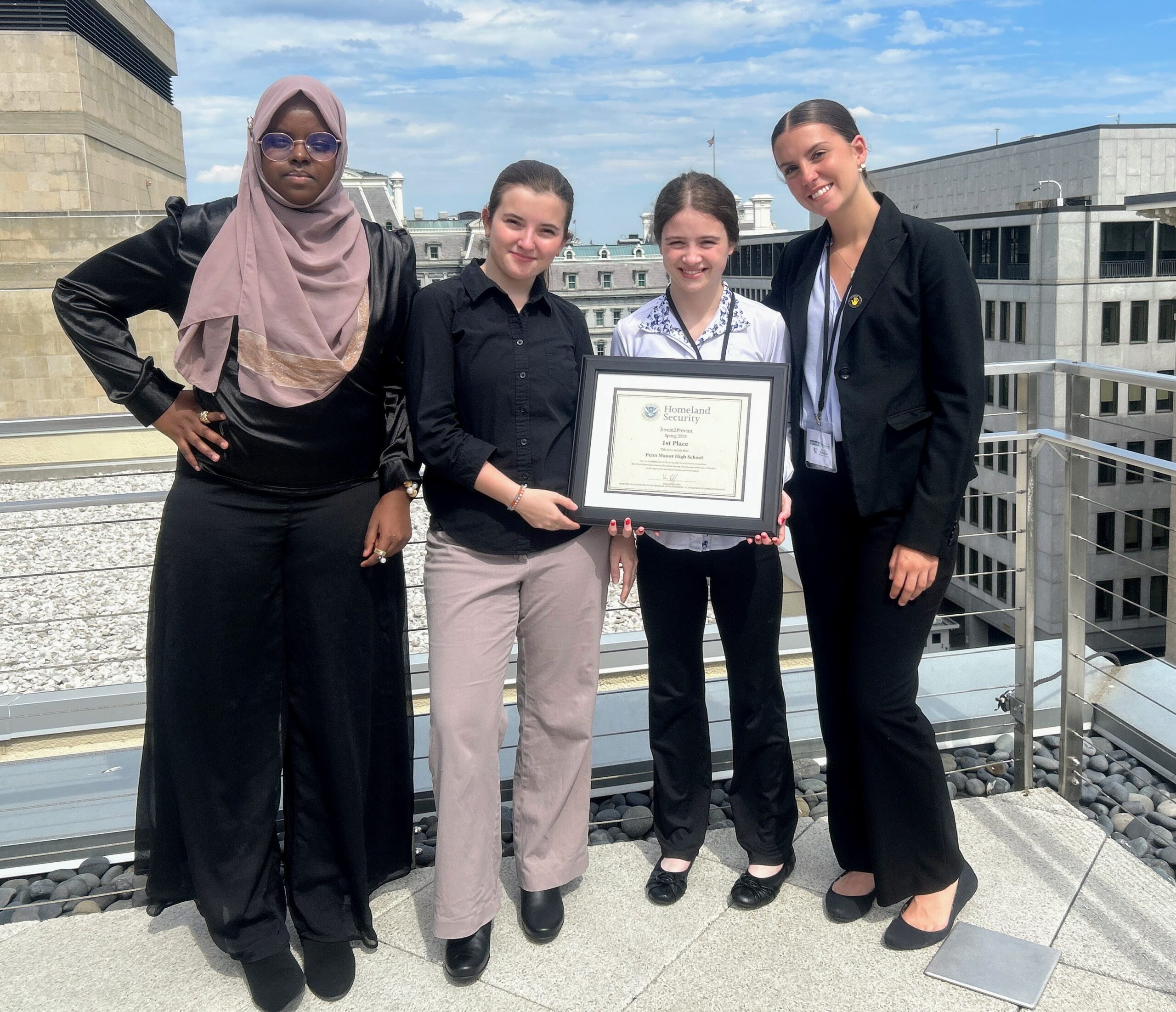 The four student presenters with their award
