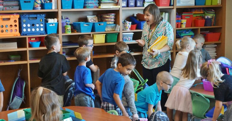 A teacher welcomes students in a Penn Manor classroom