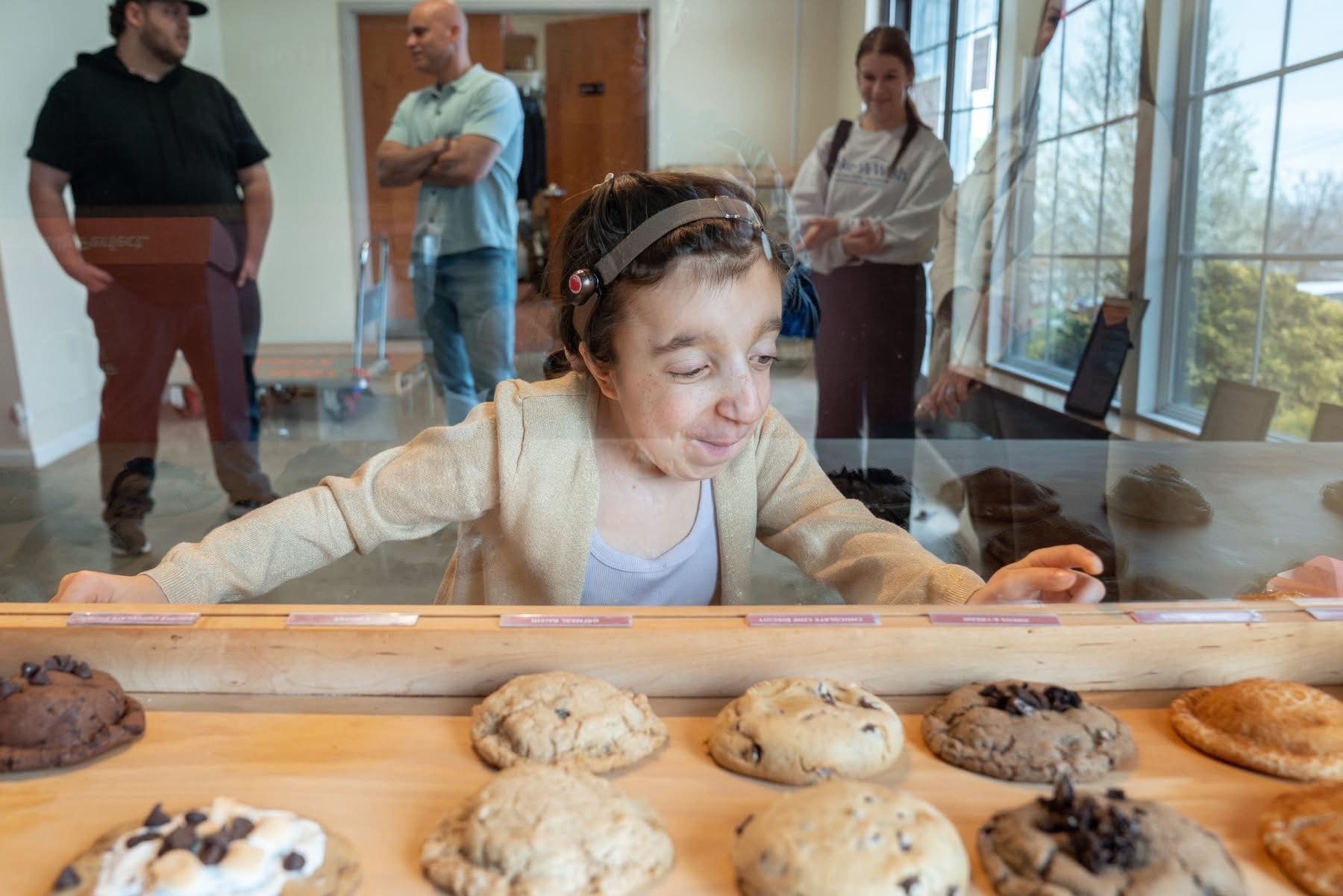 Ryley looks over cookies in a display case.