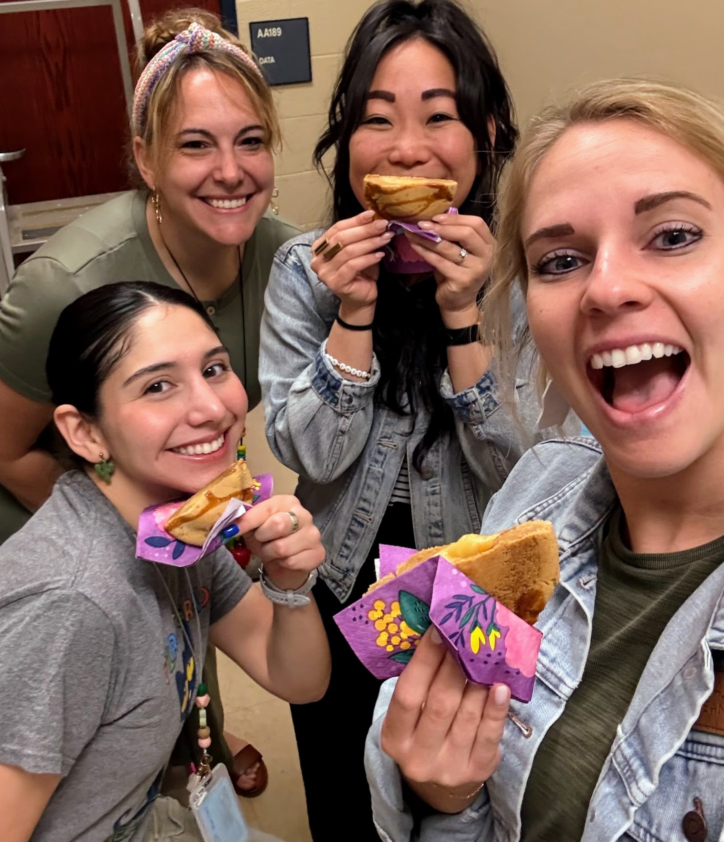 Five teachers eating cookies