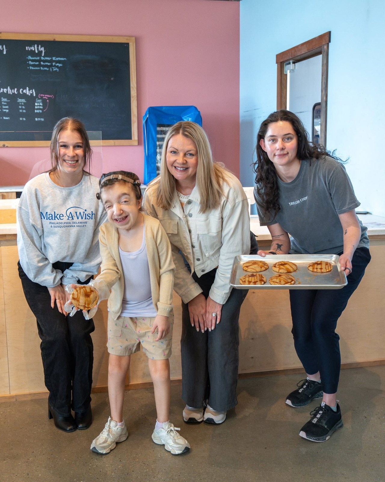 Ryley with three adults at the cookie company