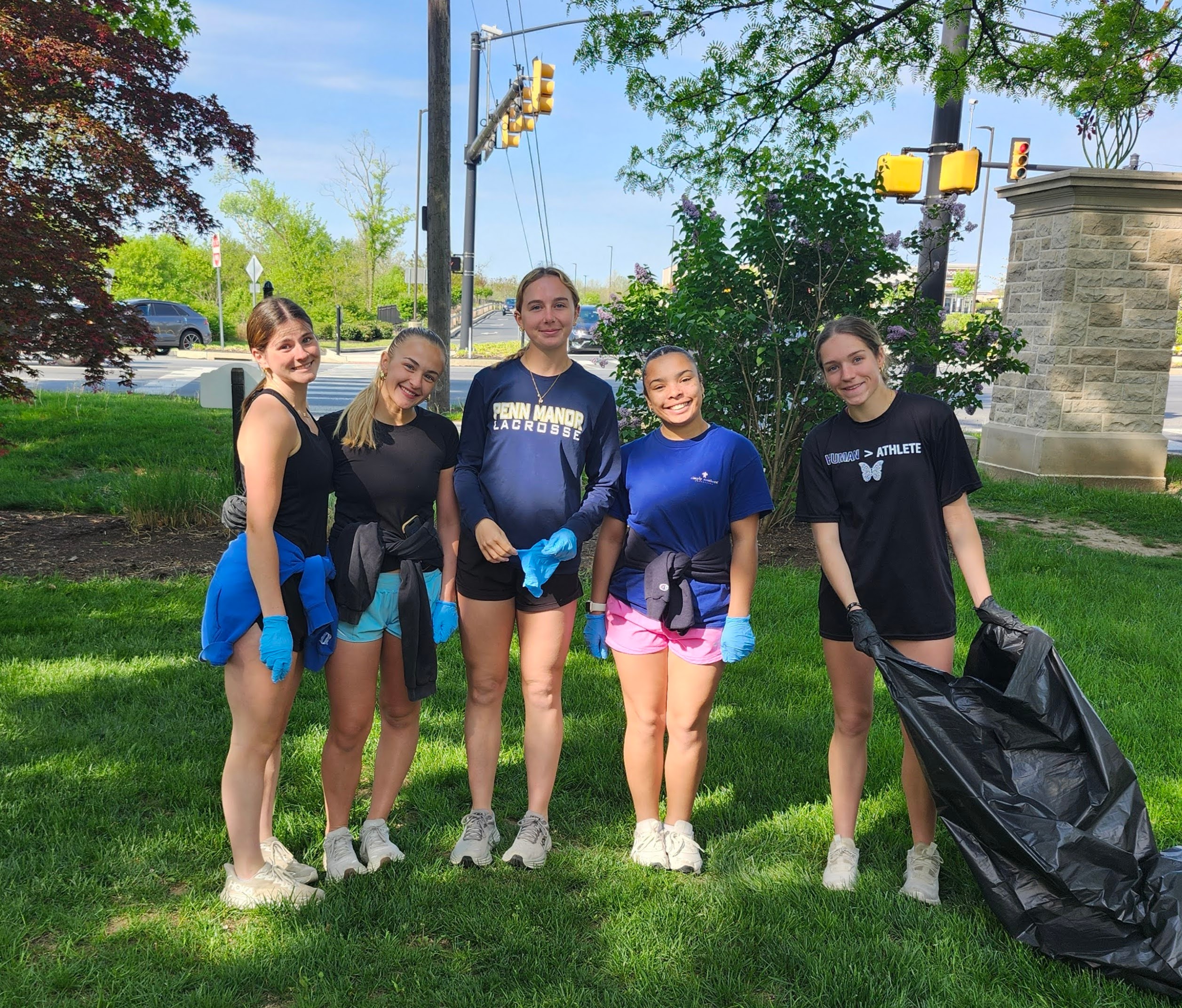 Four students pick up trash at Long's Park.