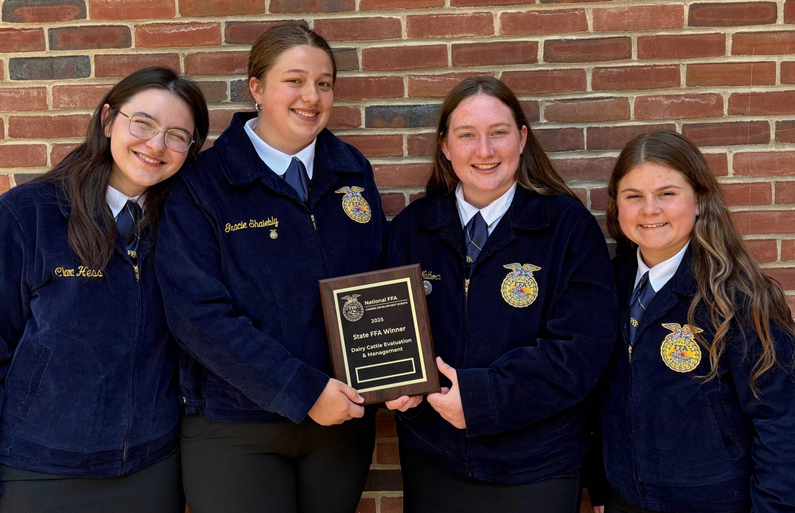 Four Dairy Cattle Management team members.