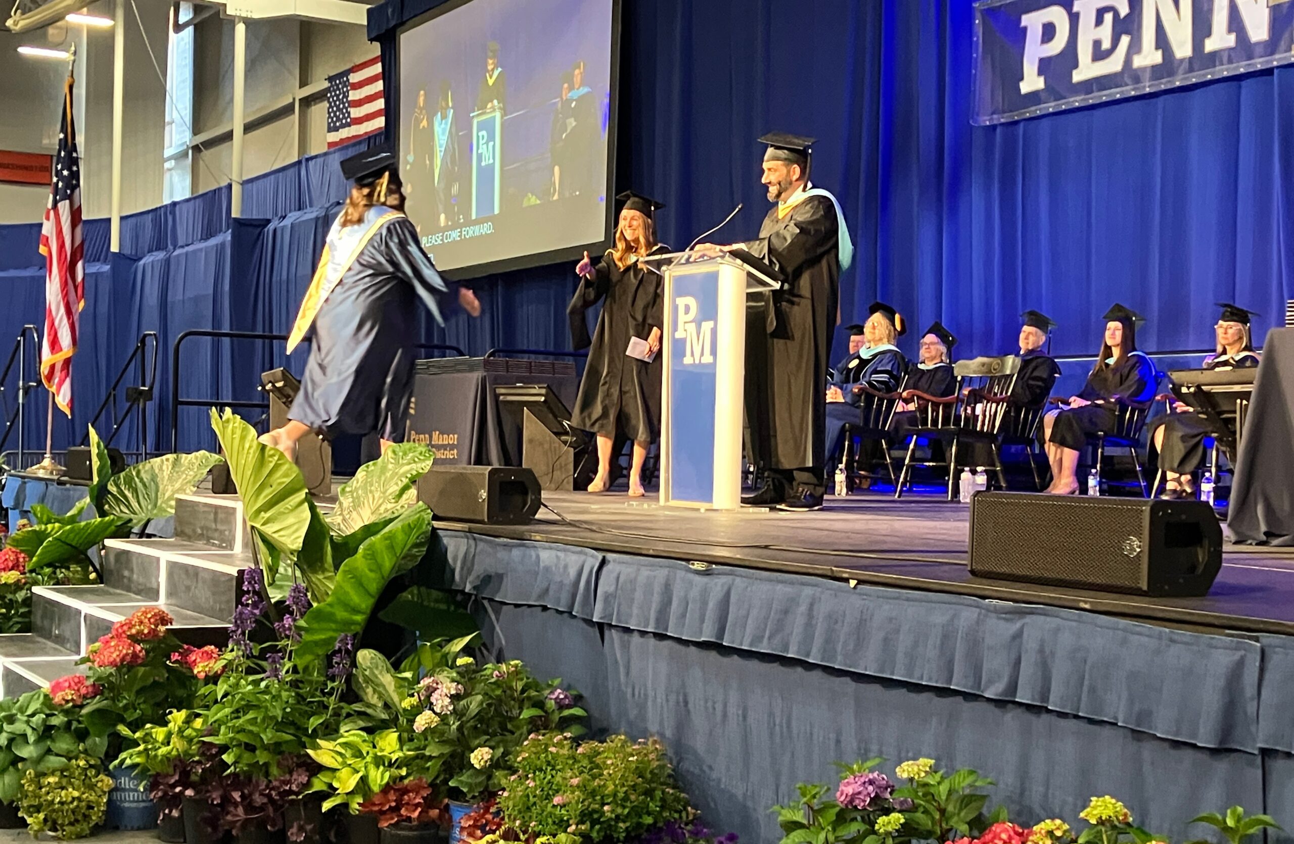 A student steps onstage to receive an award.