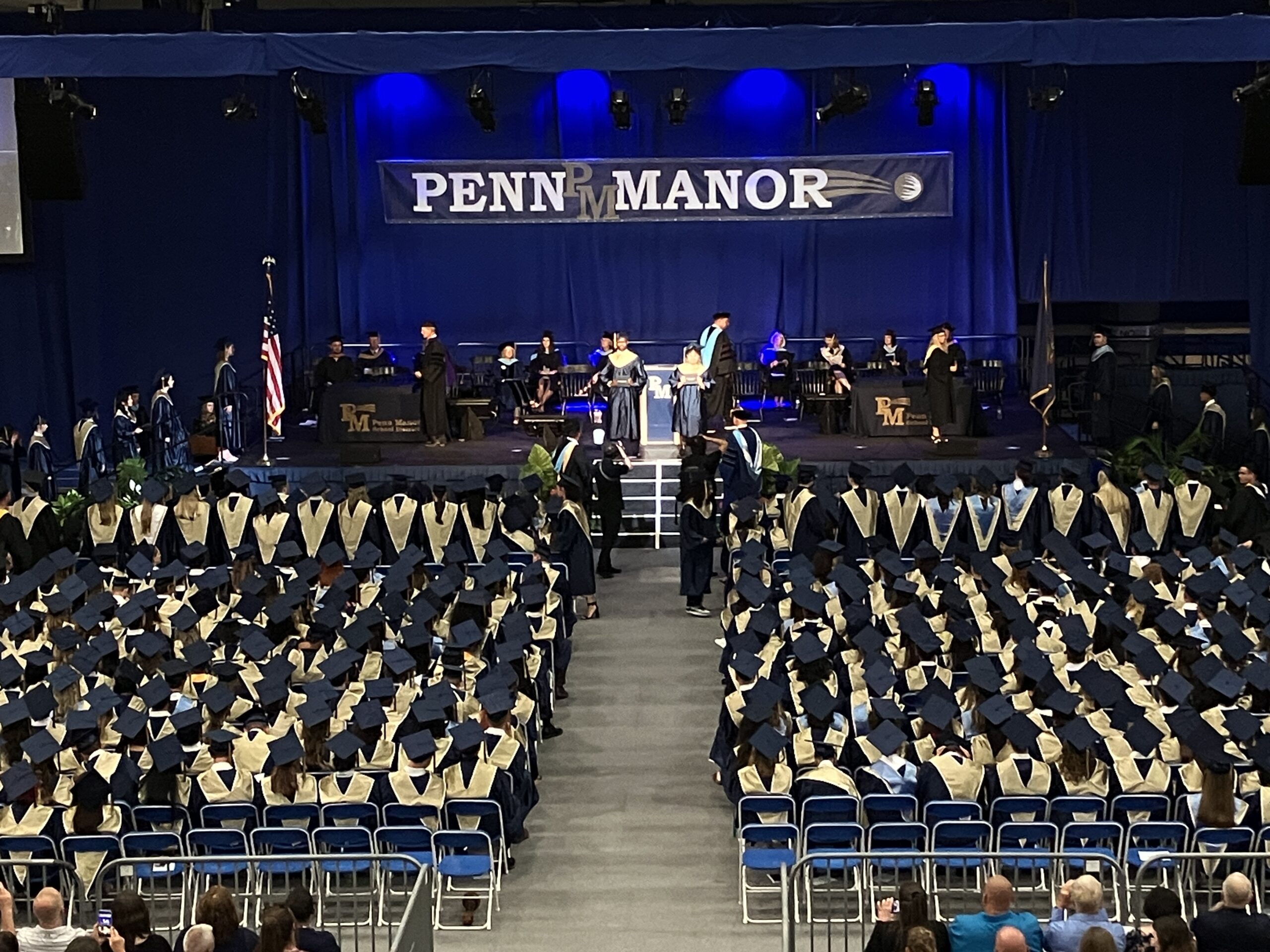 Photo of group of graduates and stage from above.