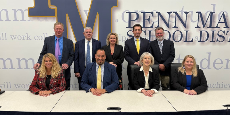 School board members seated at the school board table.