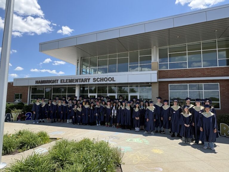 Penn Manor graduates in caps and gowns outside Hambright Elementary